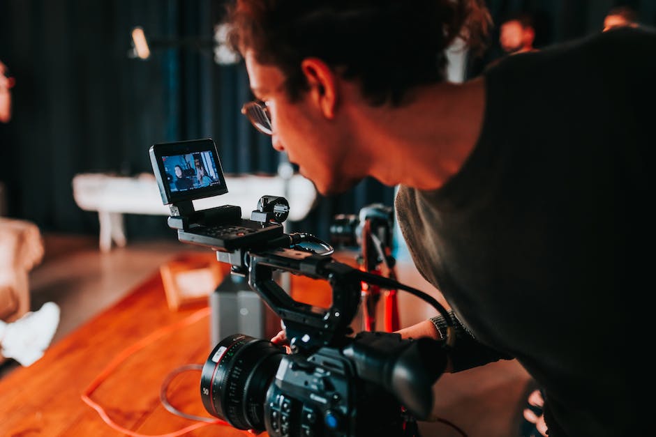 An image showing a person filming a video with a camera, symbolizing the topic of creating captivating video content for YouTube channels.