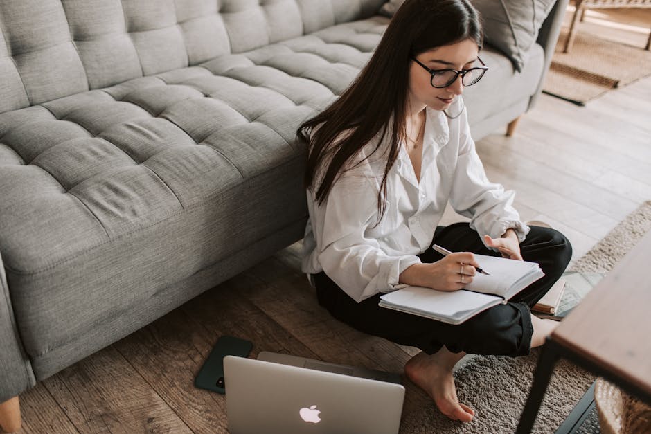 A person working as a freelancer and virtual assistant, surrounded by various digital devices and tools