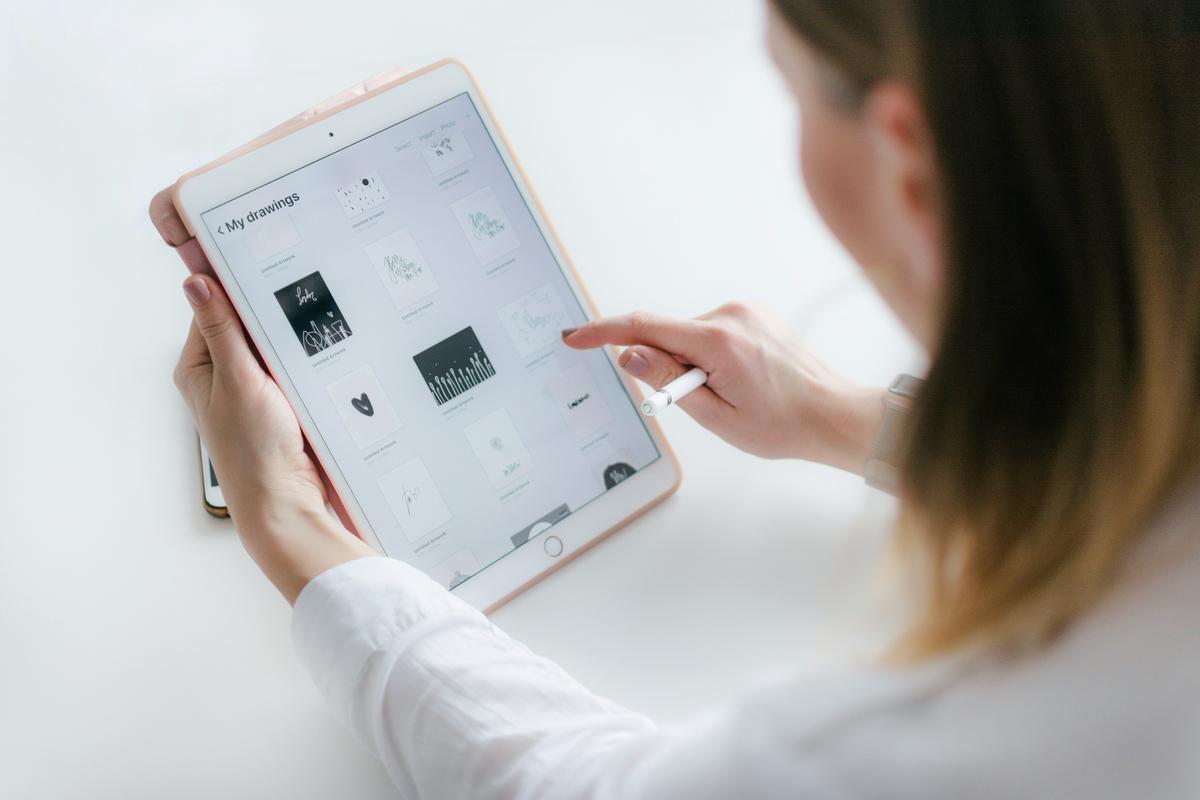 An individual completing an online survey on a tablet while relaxing at home