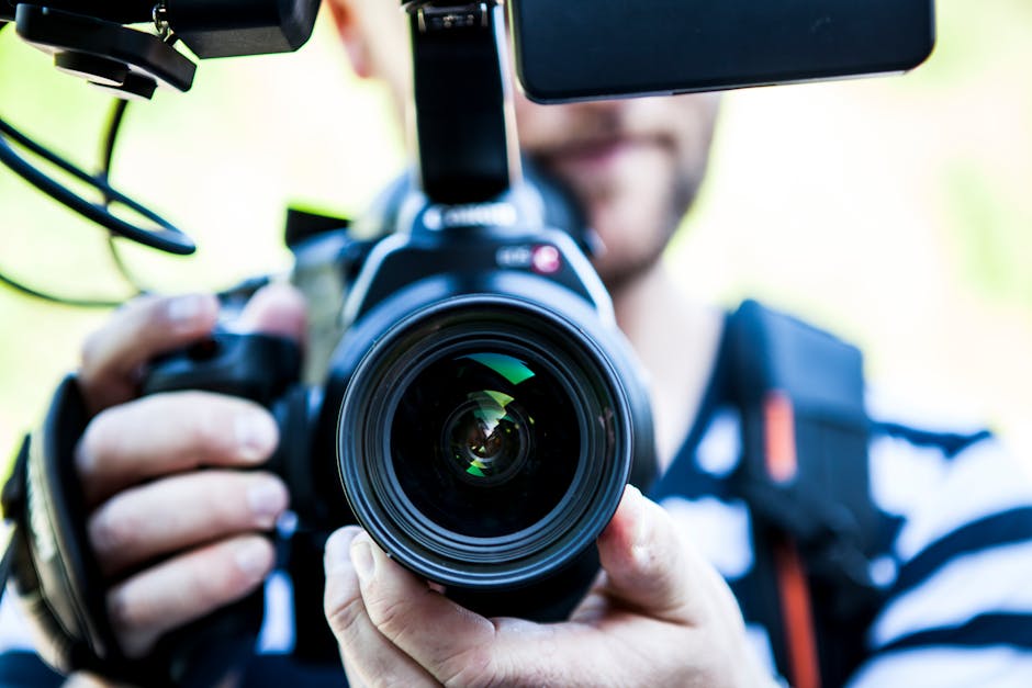 A person recording a YouTube video with professional lighting and camera setup